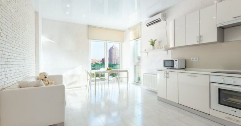 Air Conditioner - Modern kitchen with built in appliances and dining room