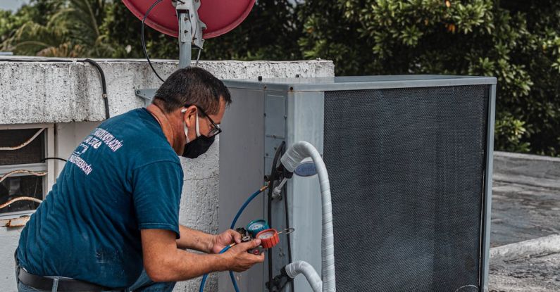 Air Conditioner - Man Checking an Air Conditioner