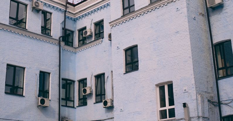 Air Conditioner - Old house exterior with air conditioning units on walls