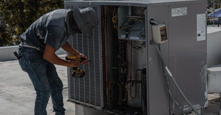 Air Conditioner - Repairman Repairing a Air Conditioner