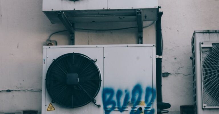 AC AC Controllers - Low angle of weathered dirty air conditioner boxes installed on shabby wall of building on street