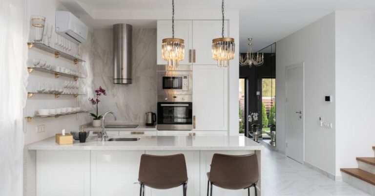 AC Installation - Interior of contemporary kitchen with modern appliances and chairs at white counter near wall with shelves in spacious apartment near stairs