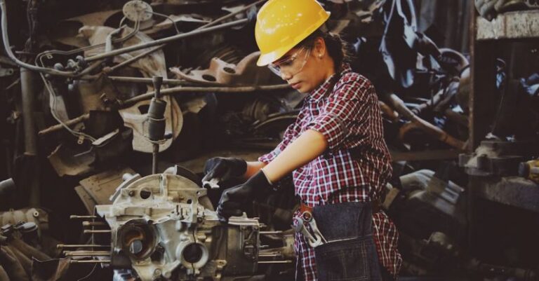 AC Maintenance - Woman Wears Yellow Hard Hat Holding Vehicle Part