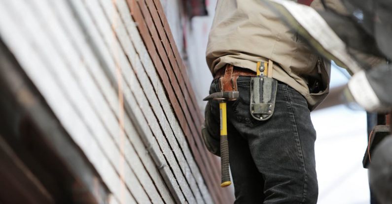 AC Maintenance - Man Wearing Black Denim Pants With Carrying Hammer on Holster