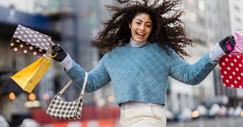 AC Energy Consumption - Happy woman jumping with shopping bags