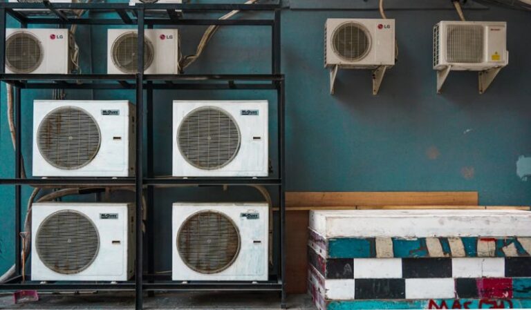 Air Conditioner - white and black box fan on brown wooden shelf