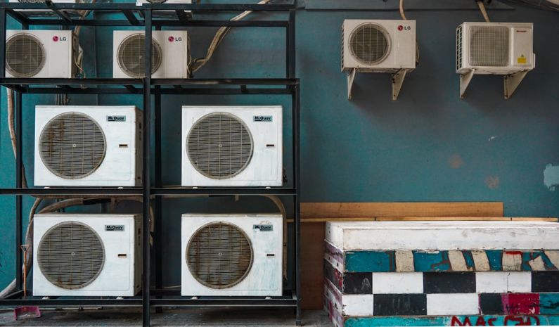 Air Conditioner - white and black box fan on brown wooden shelf