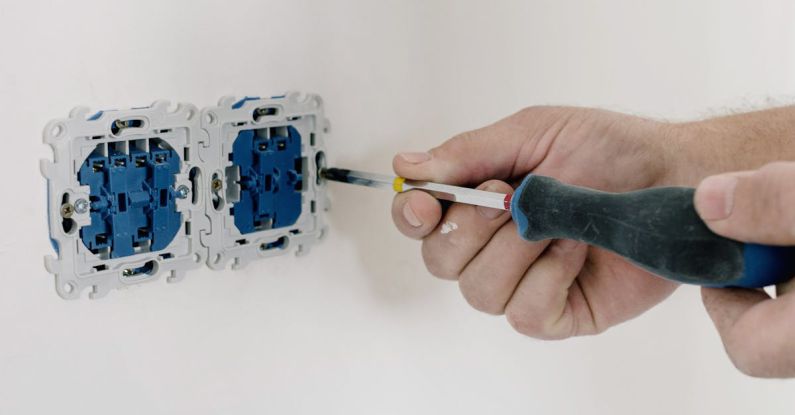 AC Maintenance - An Electrician Using Screwdriver to Repair the AC Power Plugs and Sockets