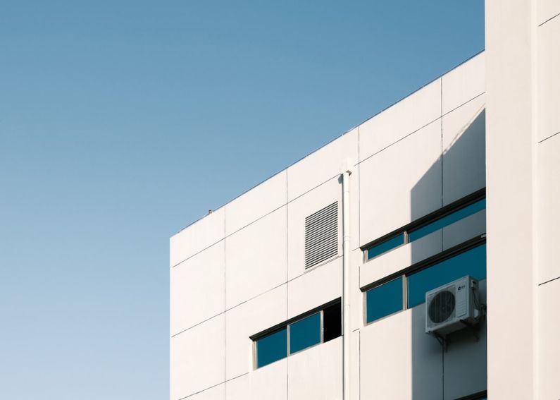 Air Conditioner - white concrete building under blue sky during daytime