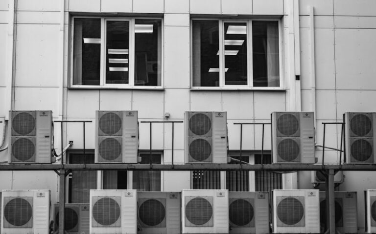 Air Conditioner - a row of air conditioners in front of a building