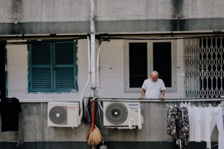 Air Conditioner - man looking downward at the apartment